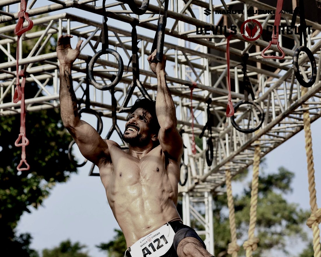 Coach Joby on the monkey bars at Devils Circuit