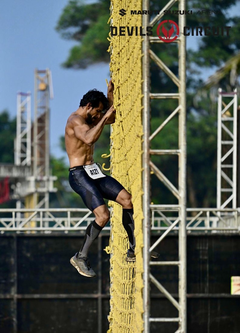 Coach Joby scaling the wall at Devils Circuit